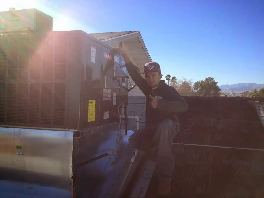 HVAC technician performing HVAC Inspection on a rooftop unit in New Haven